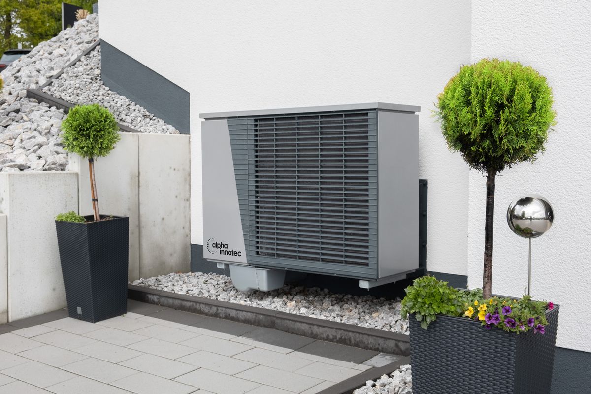 A modern outdoor air conditioning unit neatly installed beside a home by Hertfordshire Air Conditioning